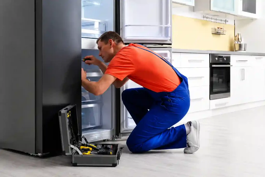 Refrigerator technician performing cooling system repair in Dammam.