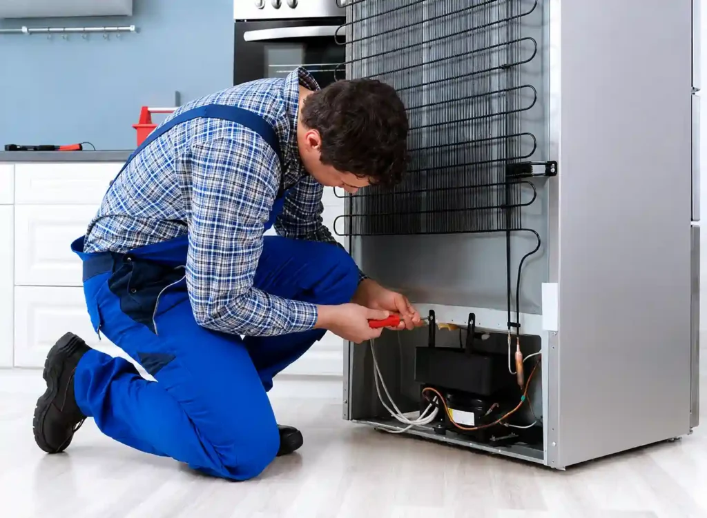 Technician troubleshooting a refrigerator in Dammam.